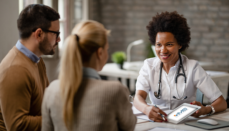 A doctor showing a mobile EHR app to her patients as a way to improve the patient experience.