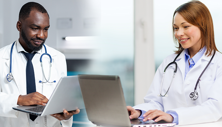 A male and female doctor typing on their laptops while chatting with each other on IMS Chat.