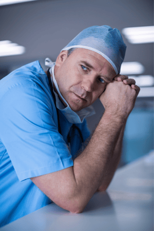 Weary Doctor contemplating office inefficiency