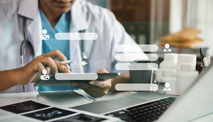 A healthcare worker using tablet with chat boxes superimposed on the foreground.