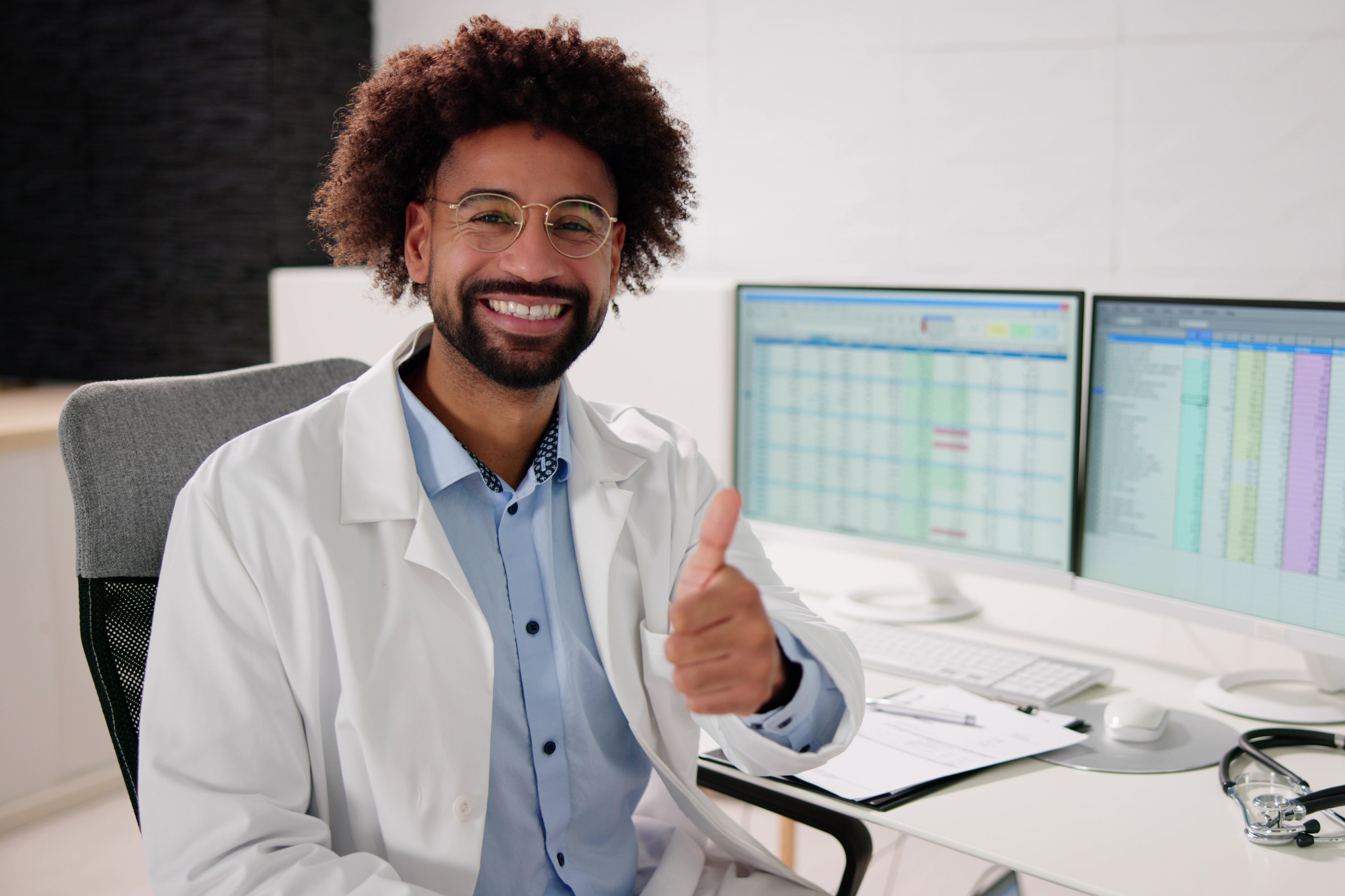 A doctor smiles as they experience the benefits of healthcare billing automation with IMS.