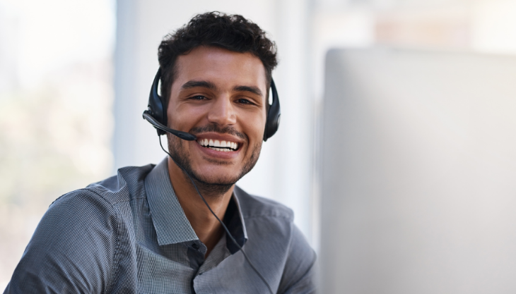 Healthcare Professional Using a Phone Headset and Happy about His More Productive Practice