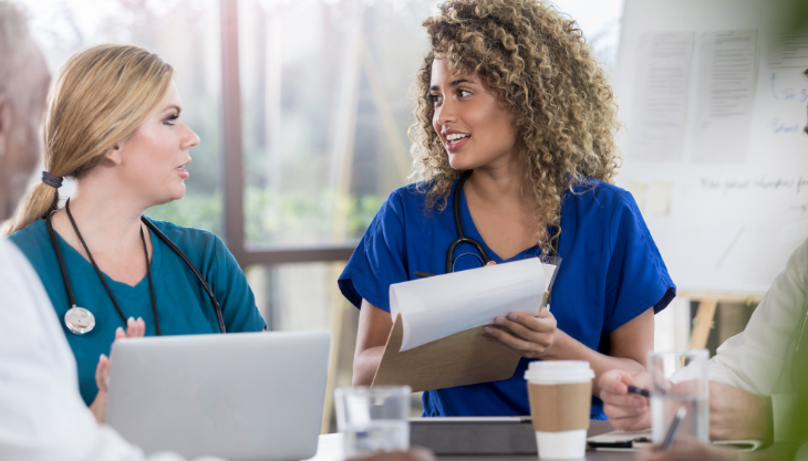 Nurse asking a peer for EHR advice