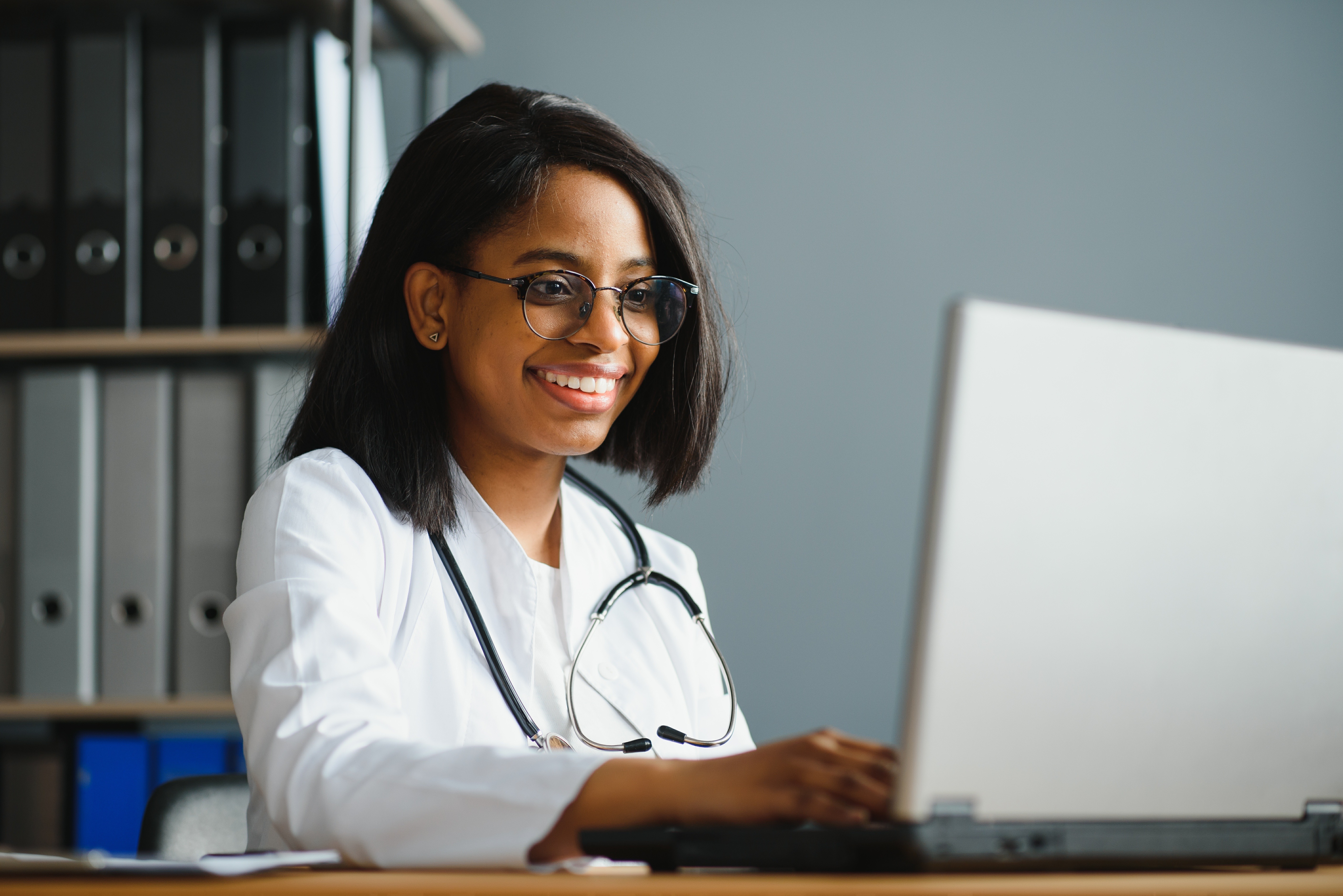 A provider happily uses IMS Chat to securely send information, understanding why HIPAA is vital to healthcare professionals.