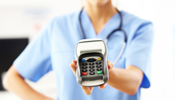 Doctor holding a credit card reader for easy payments