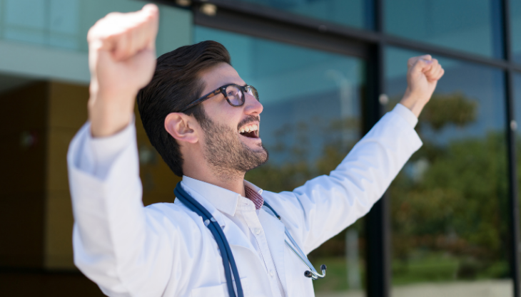 A doctor happy about setting resolutions for 2021