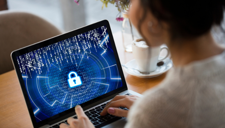 Woman on laptop using an EHR-linked telehealth platform to protect her practice and patients from cyberattacks
