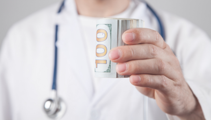 Doctor holding money to represent 2022 compensation methodology restrictions