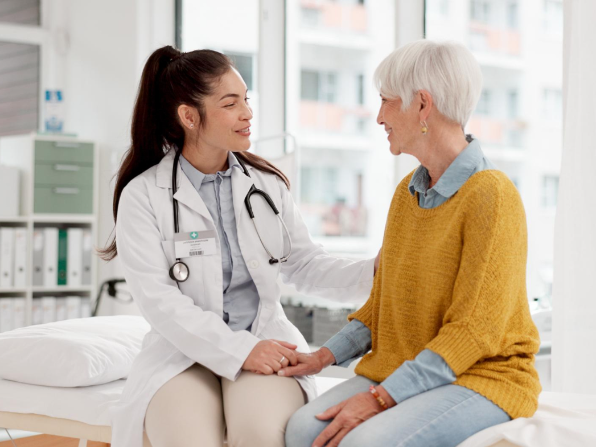 A physician ensures HEDIS compliance by talking about mammograms with a senior patient