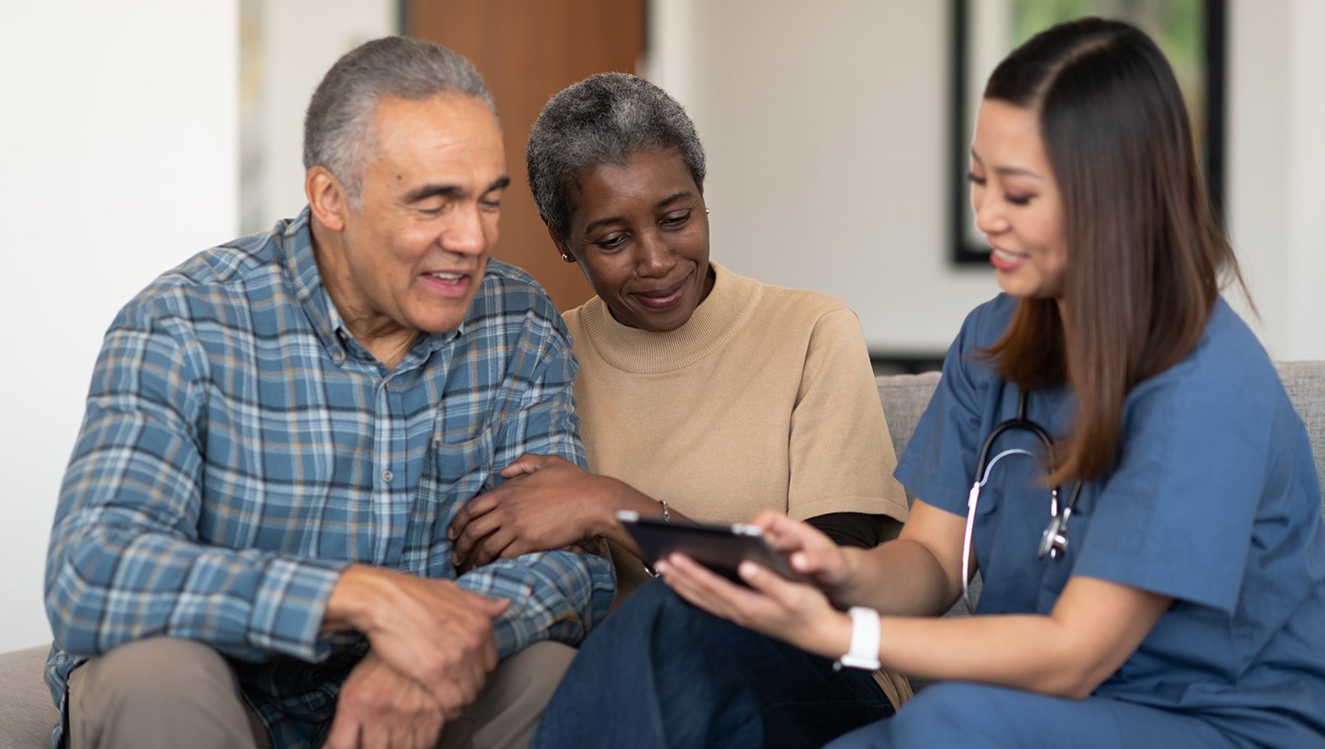 A health education specialist meeting with two patients