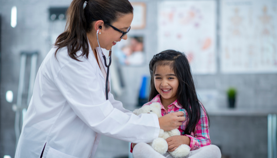 pediatric patient and provider smiling during a clinic visit